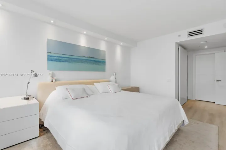 Neutral-toned wood-finish flooring, recessed ceiling lighting, and solid-core interior doors