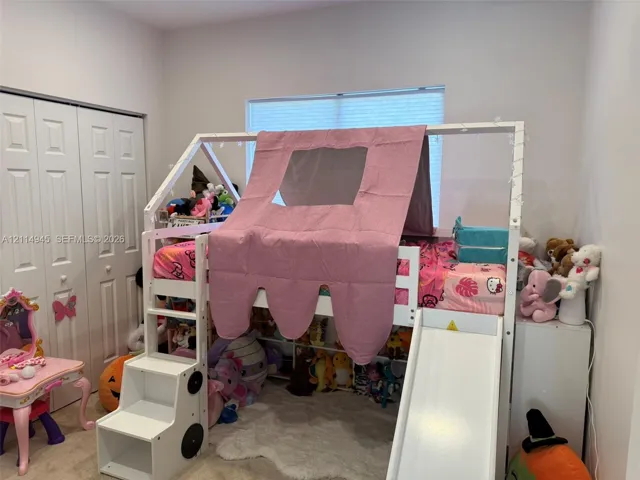 Neutral wall paint, plush carpeting, and multi-panel bi-fold closet doors