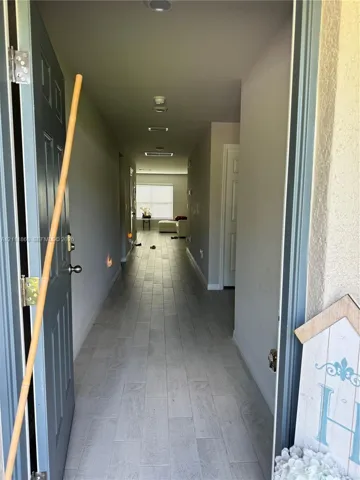 Entryway featuring neutral wall tones, ceramic tile flooring, recessed lighting, and a single-panel interior door
