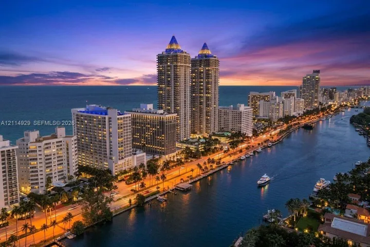 High-rise towers situated along a coastal waterway featuring marina access and panoramic waterfront scenery