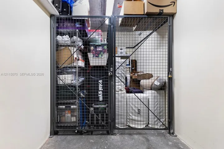 Secured storage unit featuring a metal wire mesh enclosure with a locking door