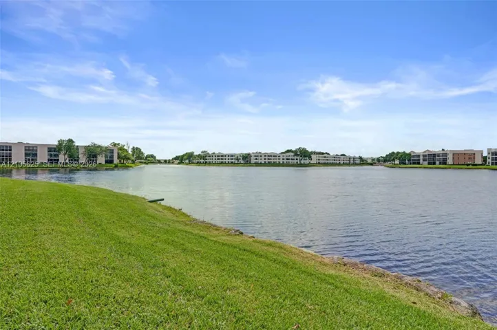 Waterfront property featuring an expansive grass lawn and lake frontage