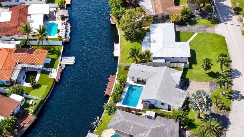 Waterfront property featuring a private boat dock, canal access, and an in-ground swimming pool
