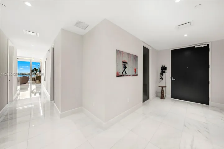 Entryway featuring polished stone flooring, recessed lighting, and a solid black entry door