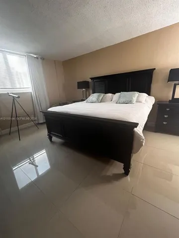 Large-format tile flooring and natural light from the expansive window