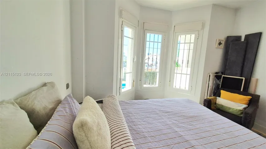 Bay window featuring triple glass-paneled casement windows with integrated security bars