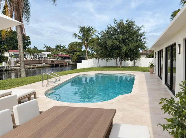 VIRTUAL RENDERING, NOT AN ACTUAL PHOTO. HOME IS UNDER CONSTRUCTION. Pool and terrace toward the canal shown as proposed per permitted plans; final construction, finishes, landscaping and furnishings may differ. Buyer to verify with developer.