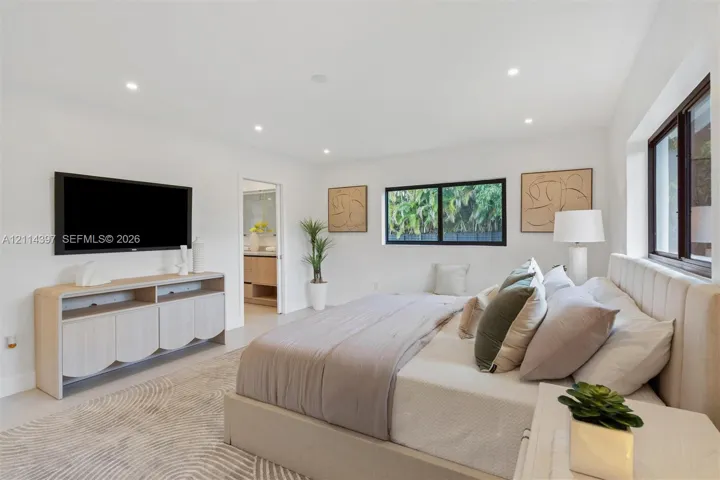 Spacious room featuring neutral paint, recessed lighting, polished tile flooring, and dark-framed windows