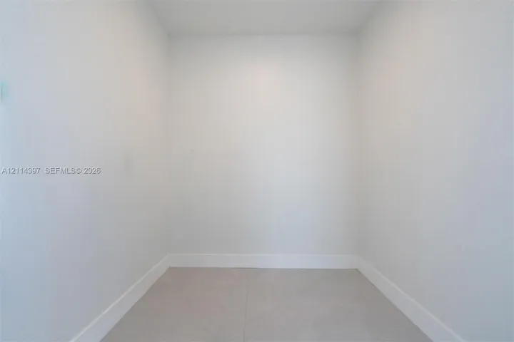 Interior space featuring neutral wall tones and large-format tile flooring