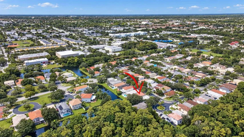 Aerial perspective of a residential property featuring a backyard swimming pool and a water-side location