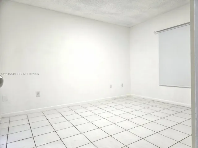 Interior room featuring white tile flooring and neutral walls