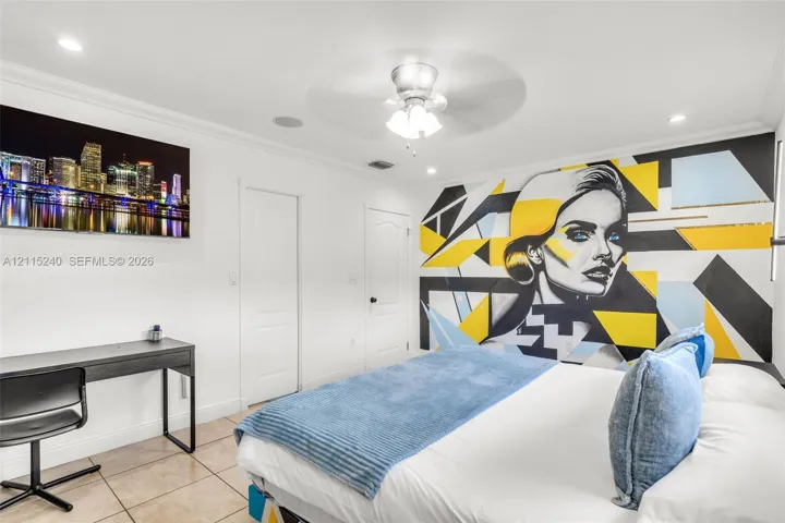 Neutral-toned ceramic tile flooring, recessed ceiling lighting, and a central ceiling fan with integrated lighting