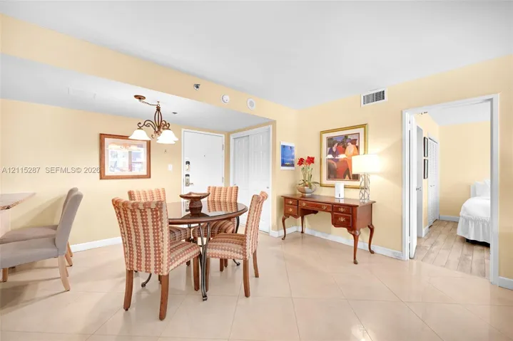 Light-toned ceramic tile flooring, neutral wall palette, and white multi-panel interior doors