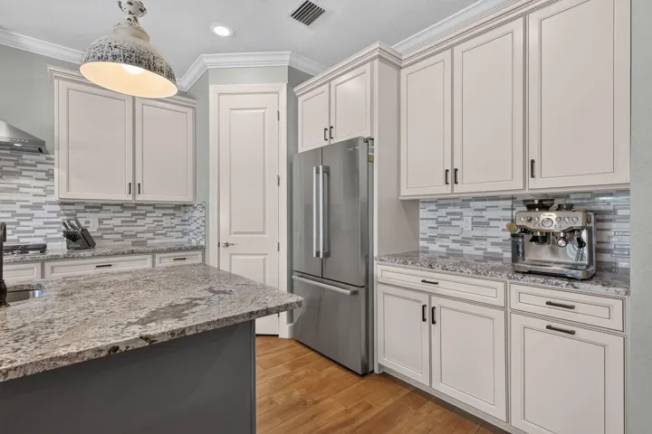 A Bosch refrigerator, generous cabinetry and custom pantry shelving bring everyday ease to a beautifully finished kitchen
