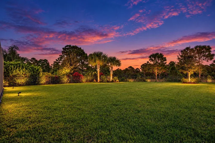 The pool shimmers, the landscape glows, and the preserve beyond gives the evening a beautiful sense of escape