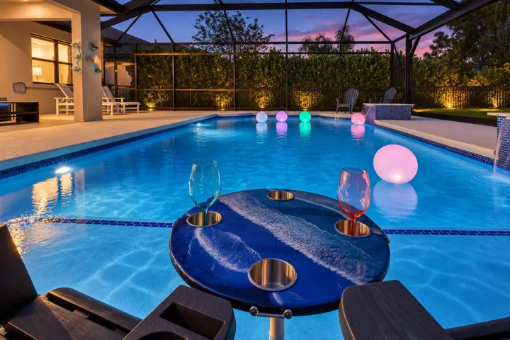 A glass of wine, the glow of the water, and the preserve beyond. An ordinary evening becomes something worth slowing down for.