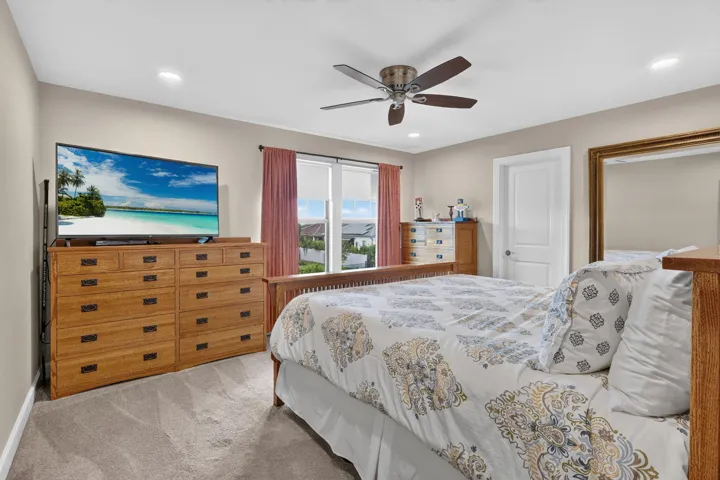 A welcoming bedroom for the people you want to stay a little longer, with soft carpeting and a calm, comfortable fee