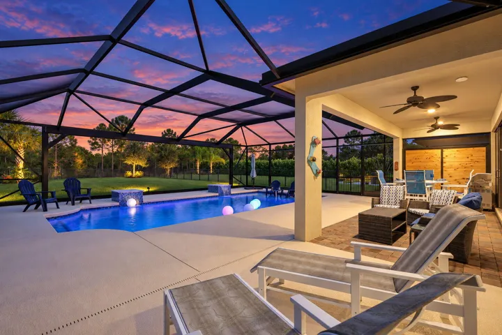 The pool shimmers, the landscape glows, and the preserve beyond gives the evening a beautiful sense of escape