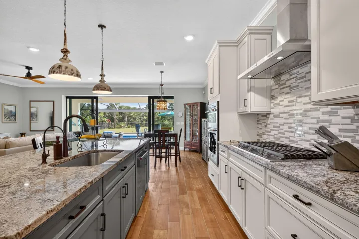 Prepare dinner with a view across the pool to the greenery beyond. Even time in the kitchen feels connected to the outdoors