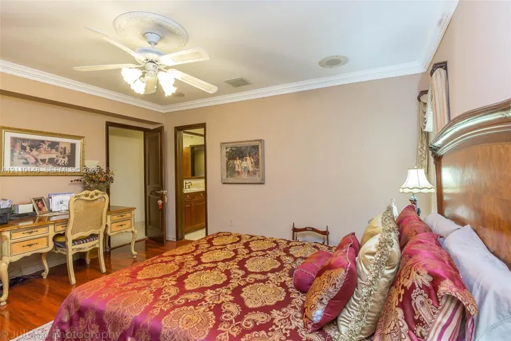 Interior space featuring crown molding, wood-finish flooring, and a ceiling fan with integrated light fixture