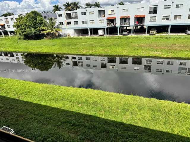Waterfront setting with a grass embankment and a concrete canal