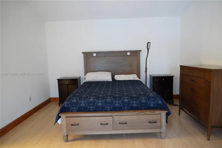 Wood-finish flooring throughout the room with neutral wall coloring