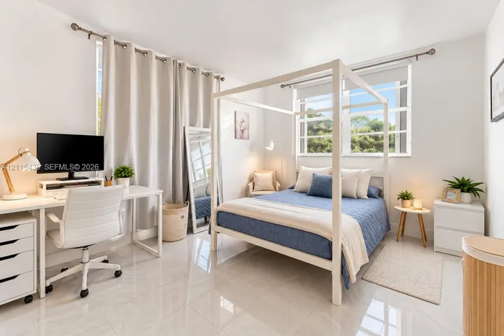 Bedroom featuring polished tile flooring, neutral walls, and dual-pane windows with metal curtain rods