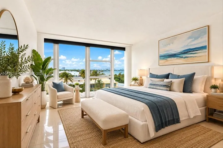 Floor-to-ceiling windows featuring coastal scenery, tile flooring, and a neutral color palette