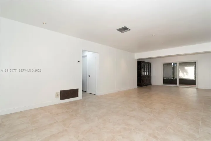Neutral interior featuring tile flooring, recessed lighting, and sliding glass doors