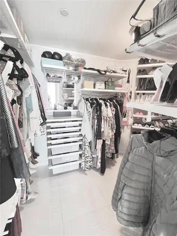 Current Master WIC with custom closet storage and hanging upgrades