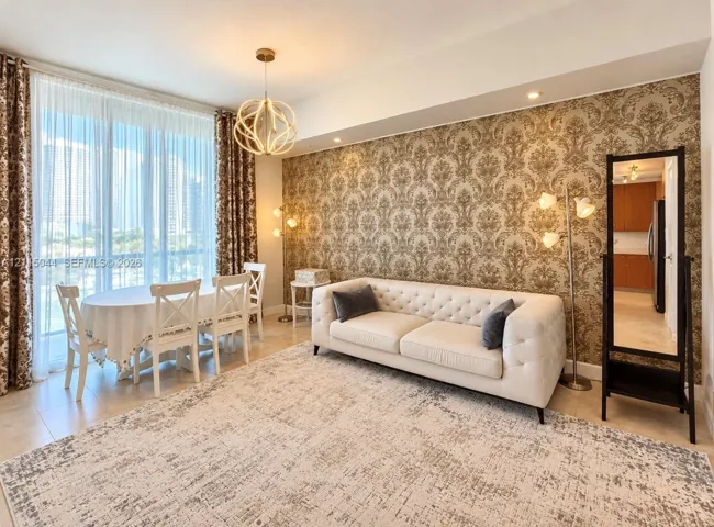Floor-to-ceiling windows, patterned wallpaper feature wall, ceramic tile flooring, and a decorative orb pendant light fixture