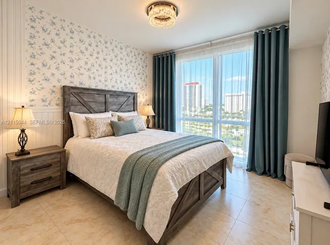 Floor-to-ceiling windows featuring urban scenery, floral-patterned wallpaper, beadboard wall paneling, tile flooring, and a decorative crystal flush-mount ceiling light