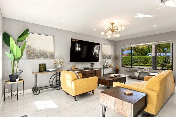 Large-format white tile flooring, expansive window with black framing, integrated recessed lighting, and multi-arm chandelier fixture
