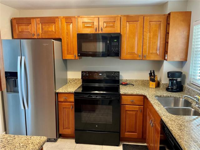 Kitchen area with Granite and New refrigerator.