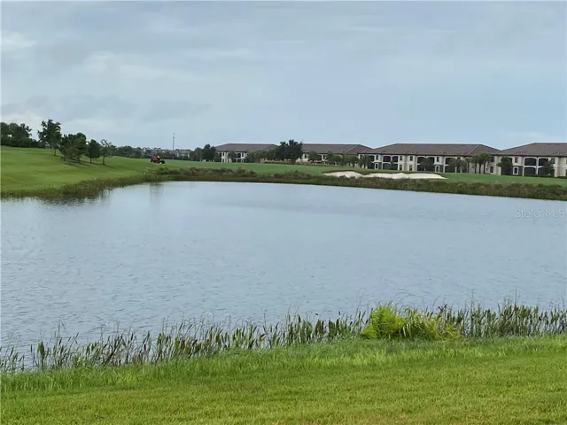 back lanai lake and distance golf course view