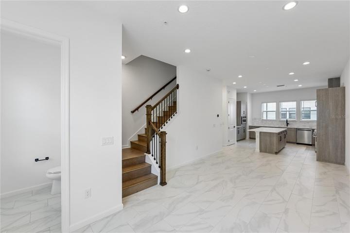 Second floor. Kitchen, living room, dining room and half bath. Tall ceilings and windows.