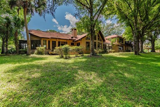 Nestled among mature oak trees and on a private pond and creek, enjoy the serenity of this Florida ranch home with its own runway/airport FL43.