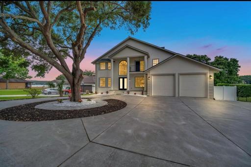 Front of home boasts double door entry, circular drive for plenty of parking, 2 car oversized garage for all your lake toys or even a small RV plus a balcony off 3 of the bedroom and/or bonus rooms