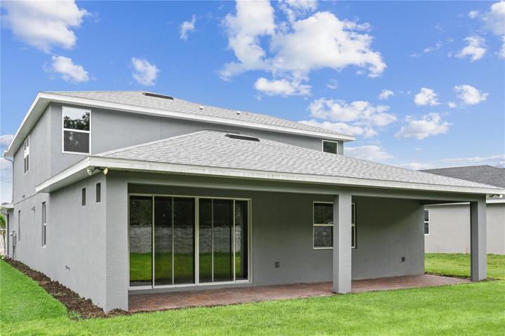 Covered lanai with triple sliding glass doors