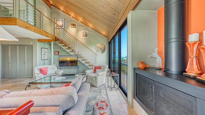 Two story wood ceiling, architect designed staircase to master bedroom