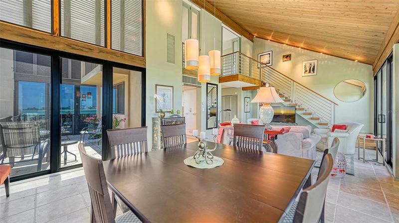 looking toward the stairs to the master bedroom and through sliding glass doors to the terrace.