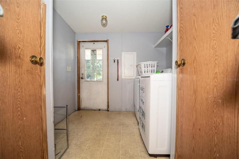 Laundry room with access to back yard