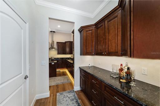 Hallway off the kitchen leading to the game room. The door on left is the walk in pantry