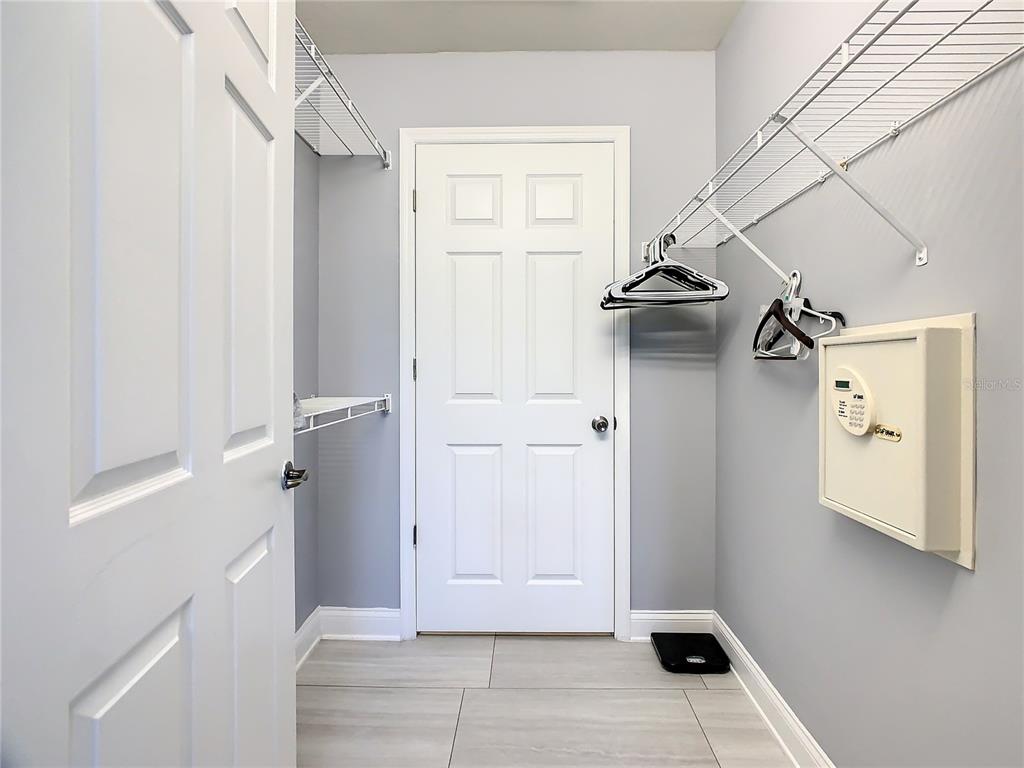 Walk in closet with safe and owners closet in the back
