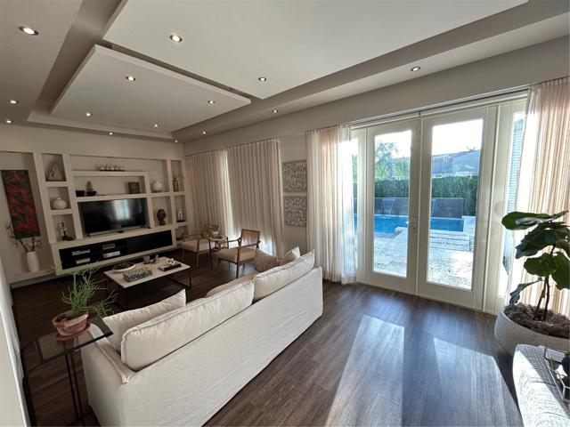 Family Room doors open completely to pool area bringing the outside in