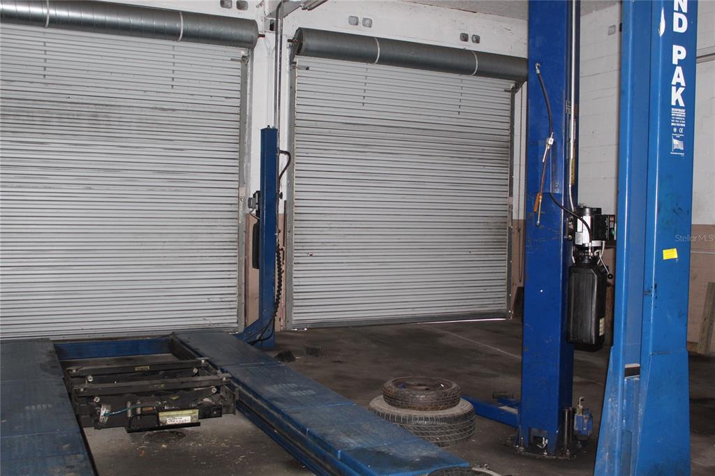 Tire shop and oil change bay with two lifts
