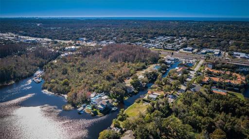 Facing South/West, displaying Cyprus Dr, the canal, and neighboring properties.