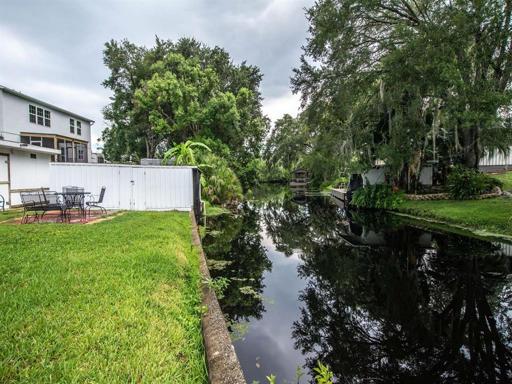 Canal view showcasing the boat house with an electric lift