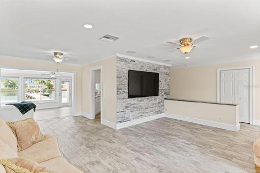 Main living room TV area looking toward pool and canal