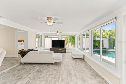 Enclosed Florida room and TV area looking toward pool